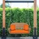 Honey Resin Wicker Porch Swing with Orange Cushion